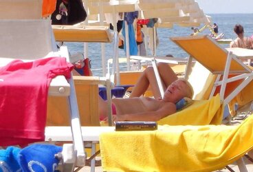 Dolls sunbathing on italian beach of the adriatic coast