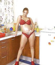 Pregnant black-haired dildoing her cunny in the kitchen