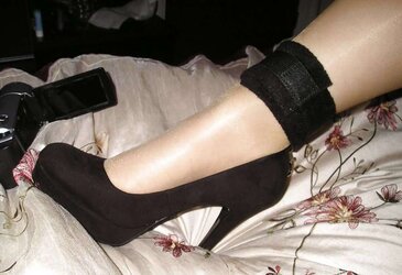 Suntan pantyhose and ebony high-heeled shoes
