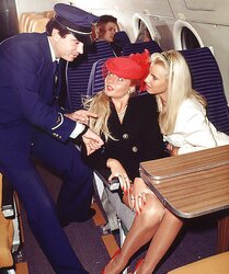 2 blondes servicing the captain on an airplane