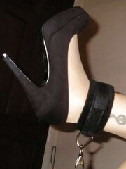 Suntan pantyhose and ebony high-heeled shoes